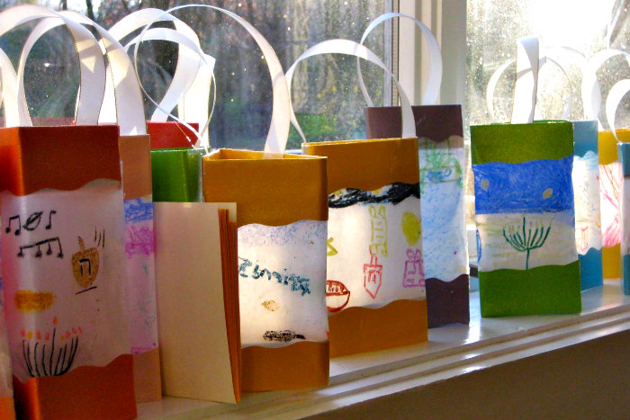 Row of handmade Hanukkah lanterns on a window ledge